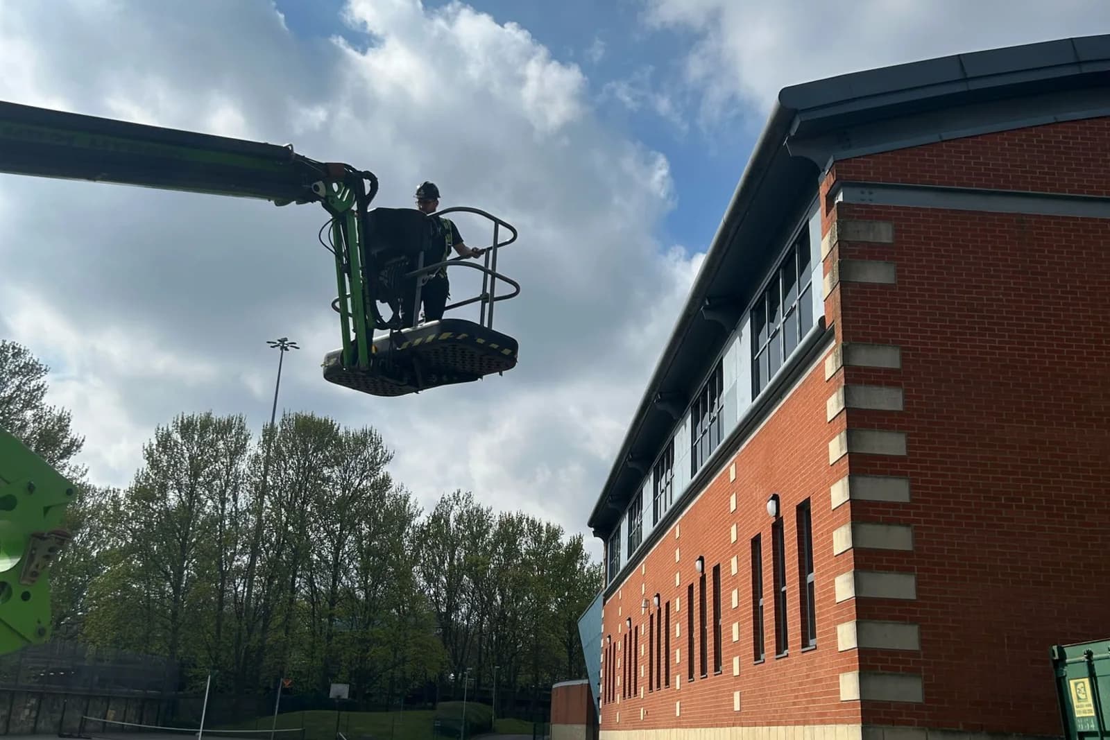 Articulated boom platform raising an operative to commercial roof level for rapid access — emergency roof repairs County Durham