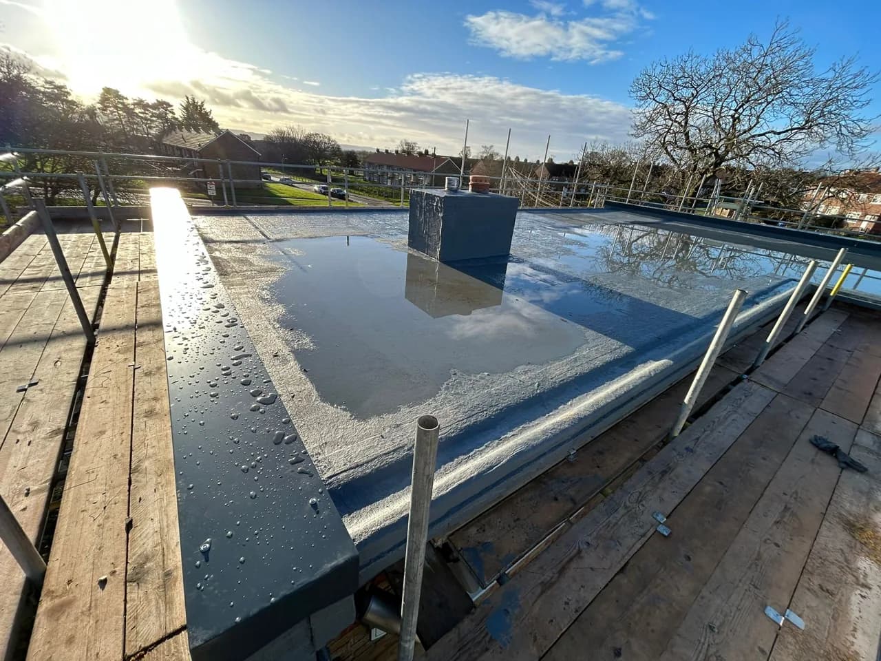 Triflex liquid-applied roofing system installed around upstands and roof details at Eastfield Clinic.