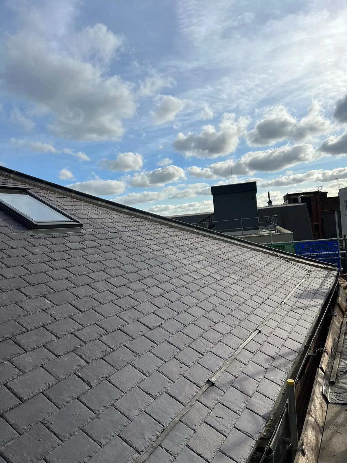 Completed Welsh slate covering at Leeds Grand Theatre with new lead detailing, rolltop ridge and rooflight in position.