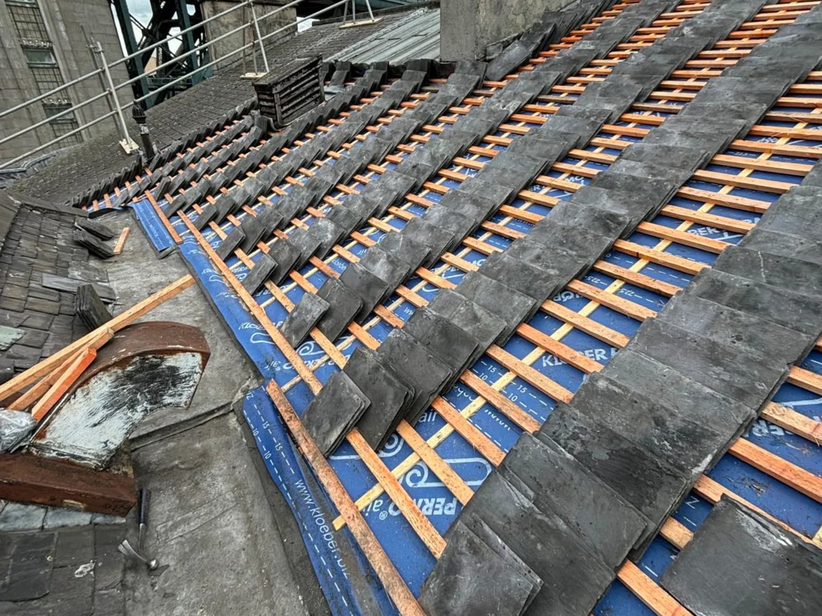 Natural slate being laid over breather membrane and treated battens during a heritage re-roof — heritage roofing contractor County Durham