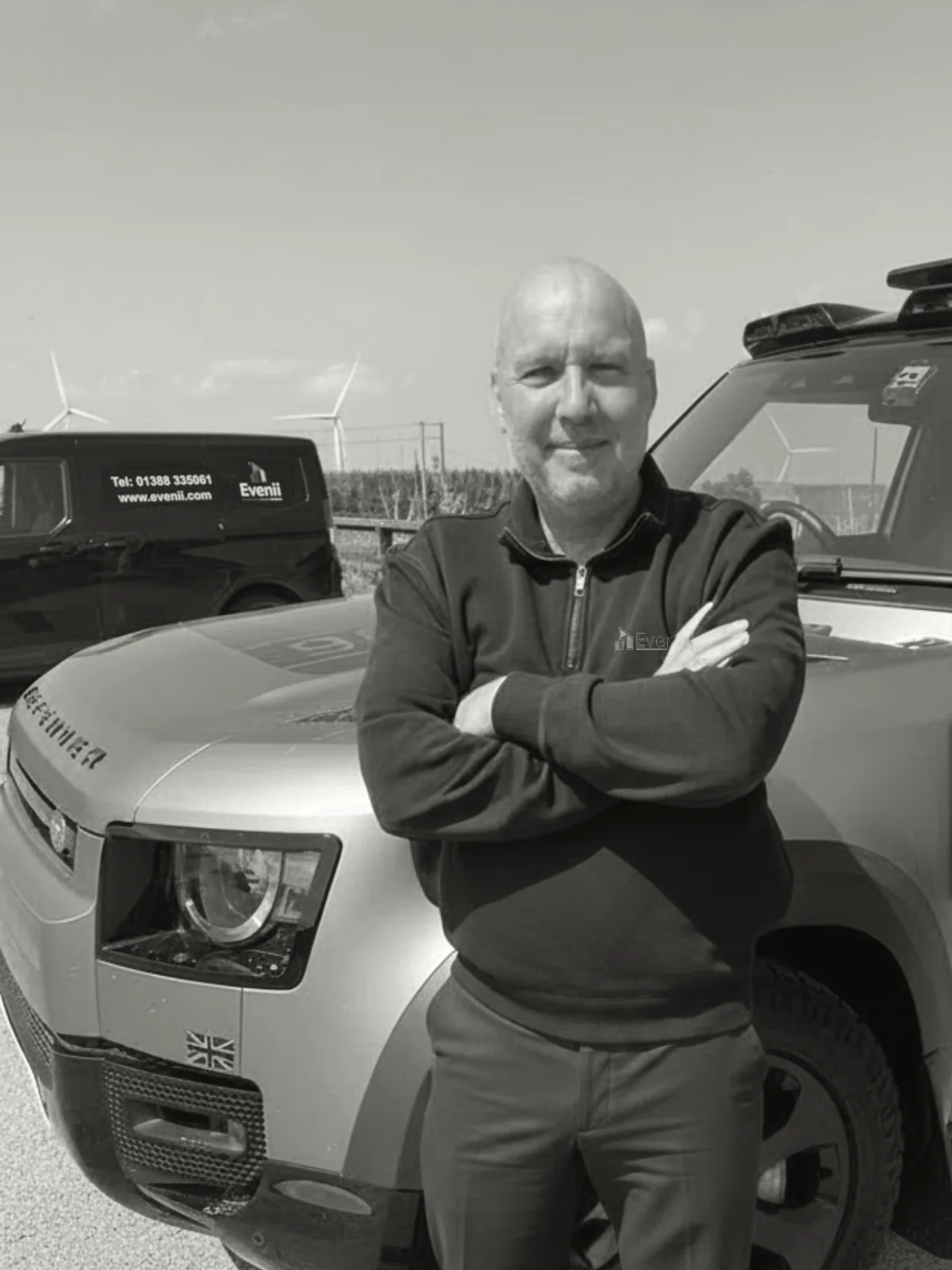 Dean Goyns, operational lead at Evenii, beside a branded Evenii Land Rover Defender and vehicle